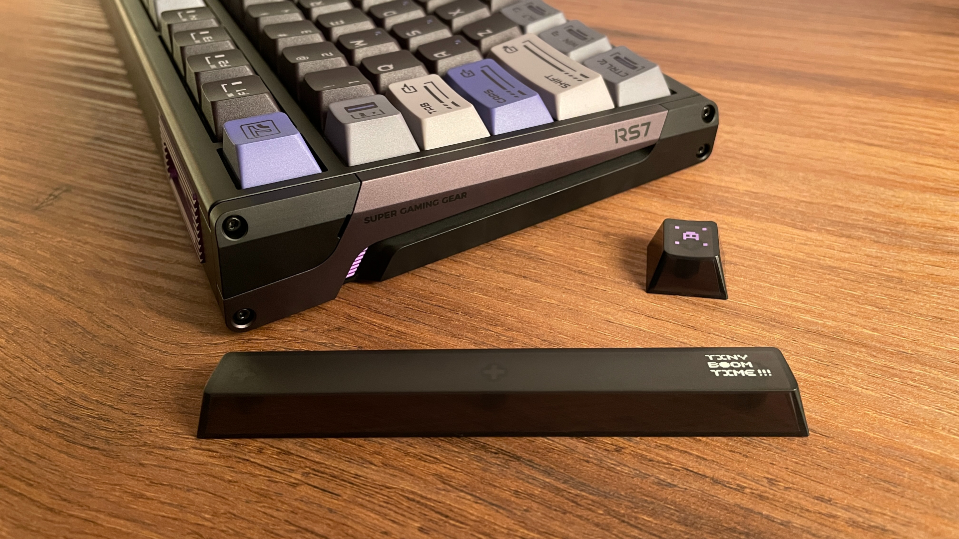 ATK RS7 V2 Ultra Review – A 75% Hall Effect Keyboard With A Twist 36 Side view of the ATK RS7 V2 Ultra with several gaming-inspired keycaps lying beside it.